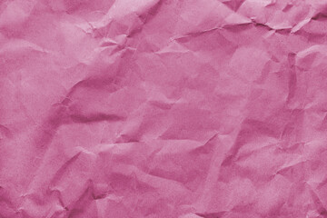 Recycled crumpled pink colored paper texture. Wrinkled craft paper background, rough cardboard surface, wallpaper, backdrop. Design element, copy space for text
