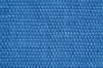 Texture of blue natural fabric with large weaving. Surface, structure of upholstery or carpet material, cloth background close up.
