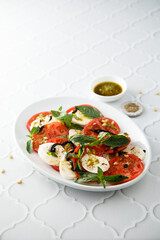 Traditional Caprese salad with pesto sauce