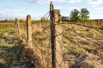 The perimeter is surrounded by the remains of an old barbed wire fence