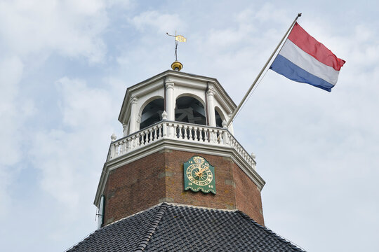 Flag in church tower during the Bildtse Rembrandt dagen. In 1634, the famous painter Rembrandt van Rijn married Saskia van Uylenburgh in de van Harenskerk in Sint Annaparochie,