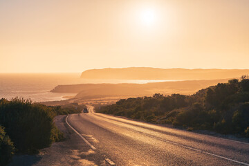 Beautiful winding road across the Innes National Park with car at sunset time