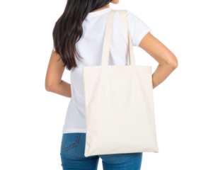 A woman carries a plain canvas tote bag over her shoulder, wearing a white t-shirt and blue jeans.