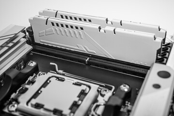 High-performance motherboard showing two installed RAM modules with a sleek heatsink design in a...