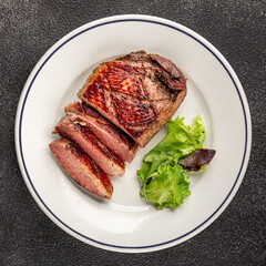 Duck breast roast meat poultry fresh delicious gourmet food background on the table rustic food top view copy space