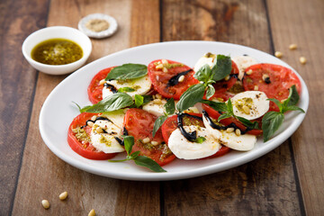 Traditional Caprese salad with pesto sauce
