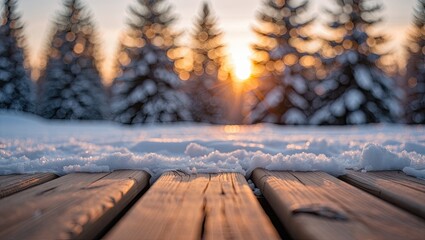 Wooden deck in a snowy winter landscape with sunlight bursting through the trees