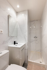 Bright compact bathroom with modern marble tile shower white sink black faucet and rectangular mirror