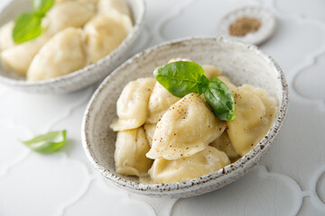 Homemade dumplings served with fresh basil