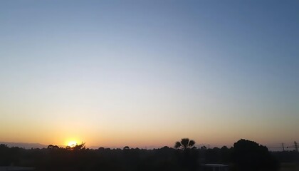 Obraz premium Serene sunrise vista of nature's awakening with gentle sky transitions
