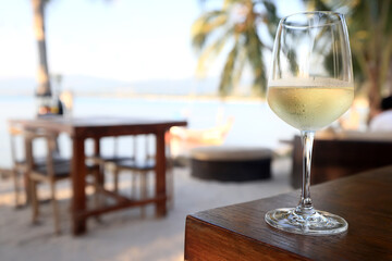 glass of cold white wine on the summer seashore by the water, relaxing by the water, a gentle background of soft color