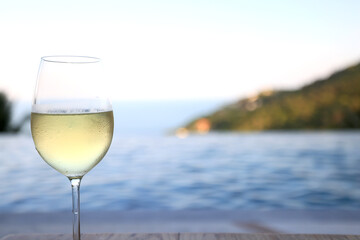 Wine glass close-up in real life, beautiful blurred background of the drink in the glass