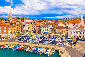 A beautiful aerial view of the waterfront promenade in Izola, Slovenia, featuring colorful historic buildings, and scenic Adriatic setting that defines this charming Mediterranean coastal town