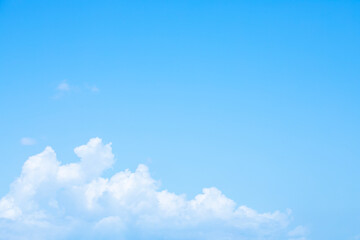 Blue sky background and white clouds soft focus, and copy space horizontal shape.