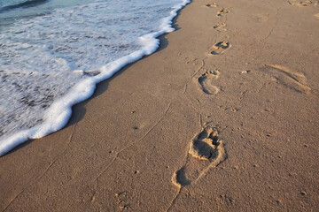 Footprints on the sand on the beach in the morning.