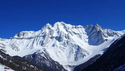 Obraz premium Majestic Snowy Mountain Peaks Against Vibrant Blue Sky Winter Landscape