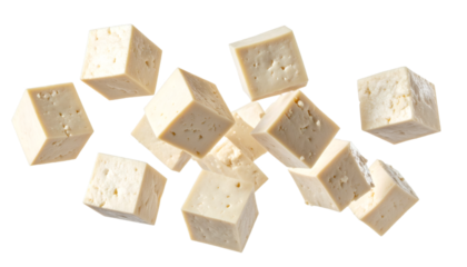 Multiple tofu cubes falling through the air with transparent background