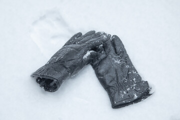 Winter leather gloves on the snow.
