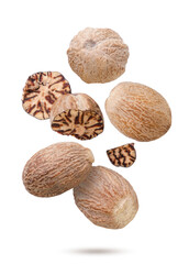 Nutmeg and broken pieces flying on a white background. Isolated