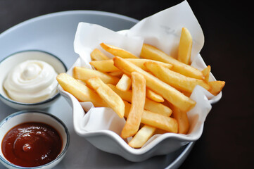 French fries or fried potato , fries with keychup and cheese dip