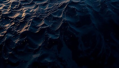 Dramatic aerial view of night ocean waves, glistening water surface