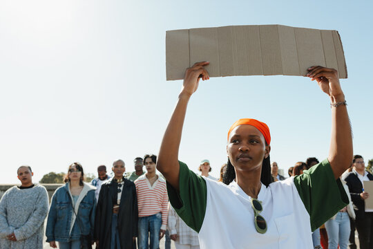 Female activist holding a blank sign during a protest for change