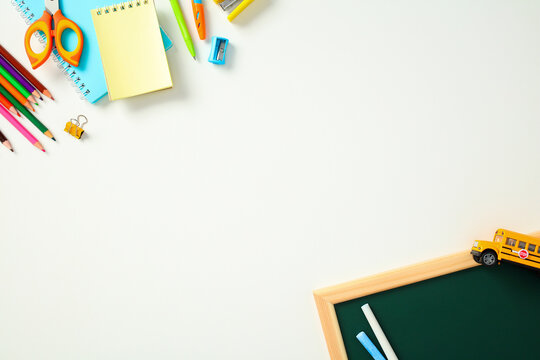 Back to school supplies on white background with copy space