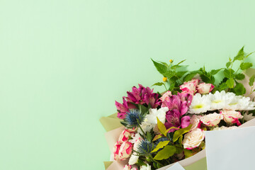 Beautiful flower bouquet on a light green background with copy space. Happy Mother's Day, International women's Day, Birthday greeting card design.
