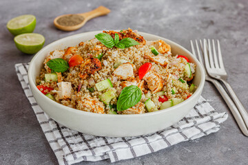 Healthy Chicken and Quinoa Salad Garnished with Fresh Basil Close-Up Photo