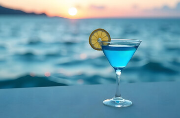 A glass of blue Lagoon cocktail and yellow lemons on the background of the sea, ocean. The concept of rest, vacation.