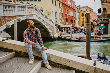 A man on a bridge in Venice