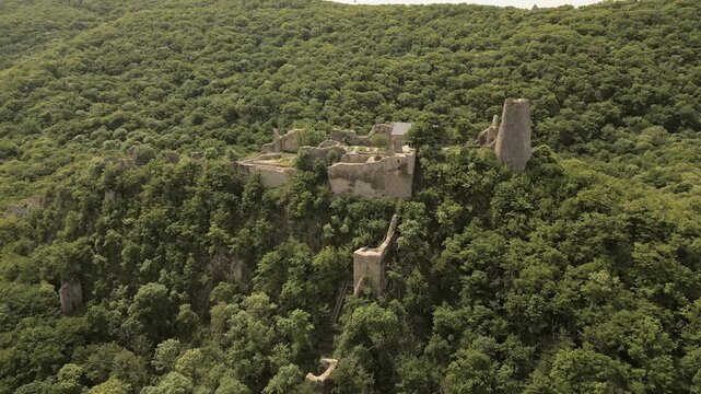 Aerial rising view Ujarma Fortress. Ancient Hilltop Royal Citadel and Strategic Stronghold of the Iberian Kings in Kakheti, Georgia. Sightseeing destination in Kakheti wine region