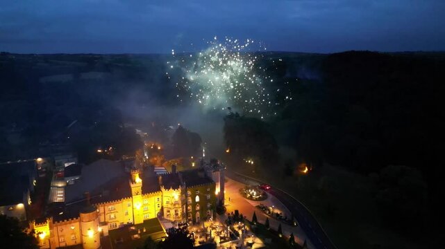 A fireworks show over a castle at night