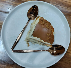 Elegant Dessert Presentation with Spoons on White Plate