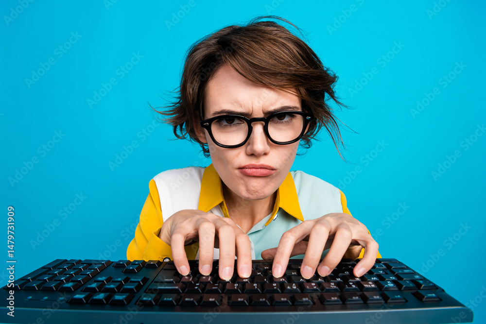 Poster Photo of grumpy manager girl working on keyboard pc computer solving problem isolated blue color background
