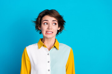Photo of doubtful unsure lady dressed shirt looking empty space feeling guilty isolated blue color...