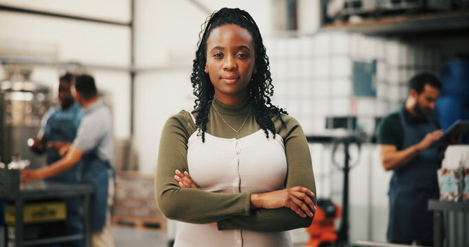 Distillery, crossed arms and portrait of woman in factory for alcohol production, manufacturing or distribution. Warehouse, brewery business and confident person for fermentation, bottling or storage