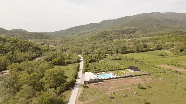 Aerial panorama highway road and Luxury Villa in Kakheti Region &ndash; Tranquil Retreat for Travel and Relaxation in the Heart of the Caucasus Mountains.Efficient Space Planning and Functional Architecture