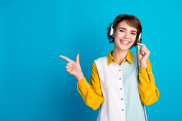 Photo of telephone operator young woman working sales manager consulting consumers point finger copyspace isolated on blue color background