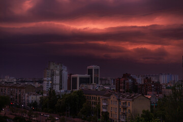 city ​​and storm clouds at sunset
