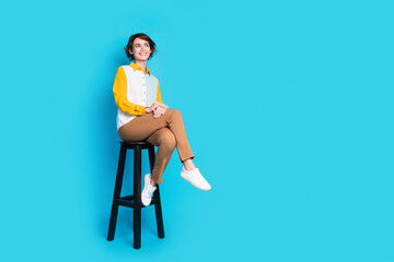 Photo of executive girl sit cafetria chair look on empty space isolated blue color background