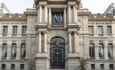 Fototapeta premium Architectural exterior splendor of The Paris Chamber of Commerce and Industry building (Chambre de commerce de Paris) is a French chamber of commerce that supports businesses in Paris. Space for text.