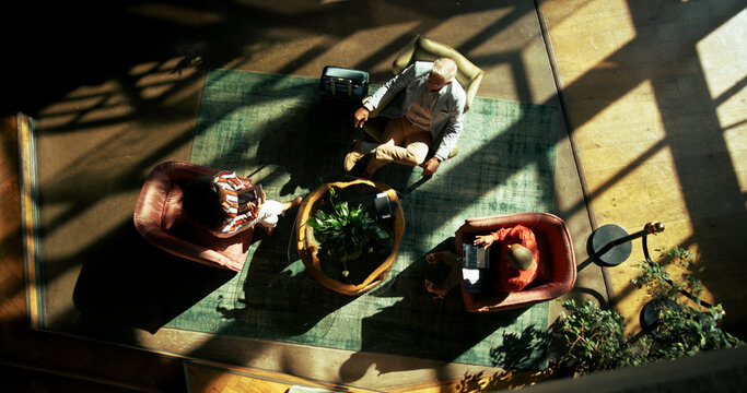Above, airport lounge and business people with luggage, conversation and waiting for flight. Passport, discussion and group with global trade, international travel and suitcase with break and ticket