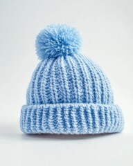 Light blue knitted beanie with pom-pom