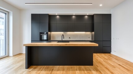 Modern kitchen with black cabinets and wooden floor, minimalist elegance in natural light
