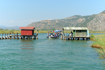 Boat passing the old fishing weir and gate on Dalyan river in Turkey