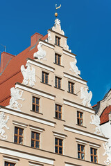 Roof top of an old ornate building with heraldic beasts in Wroclaw, Poland 