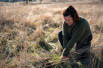 mature female farmer in a farming family. regenerative organic female farmer, taking soil samples...