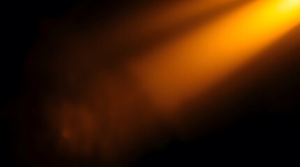 Abstract Orange Light Beam Against Black Dark Background. Warm orange light beam illuminating softly against a textured dark black background. Creating a warm and dramatic mood.