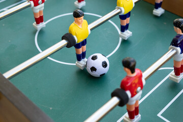 Fototapeta premium A captivating close-up of a tabletop foosball game in action. Perfect for leisure, sports, and competition themes.
